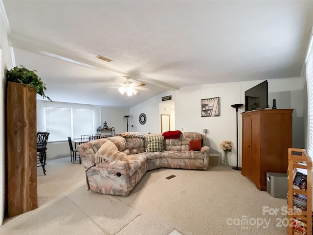 carpeted living room featuring vaulted ceiling with beams and ceiling fan