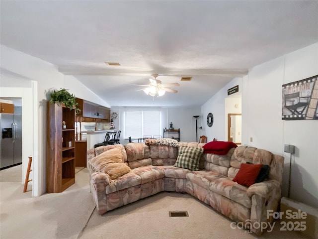 living room featuring vaulted ceiling, light colored carpet, and ceiling fan