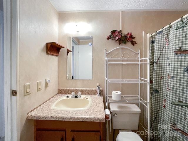 bathroom with a shower with curtain, vanity, toilet, and a textured ceiling