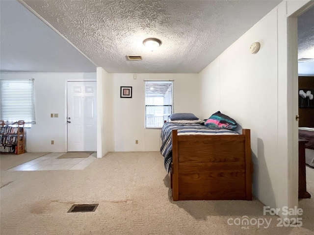 carpeted bedroom with a textured ceiling