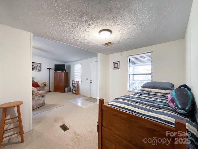 carpeted bedroom with vaulted ceiling, multiple windows, and a textured ceiling