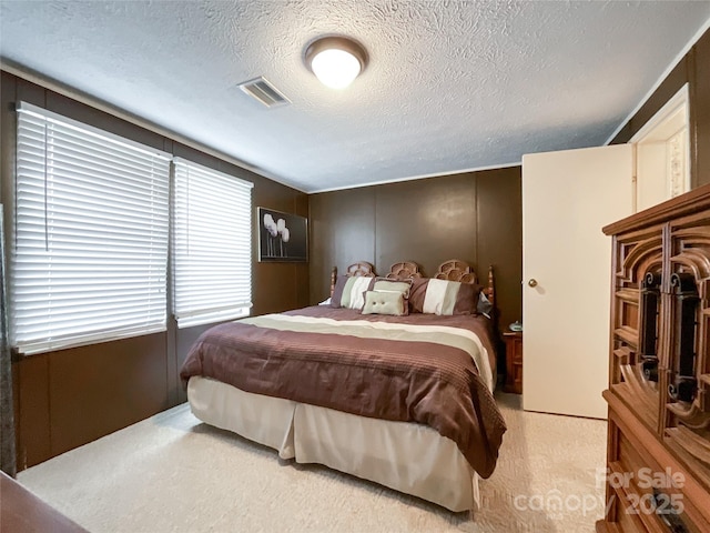 carpeted bedroom featuring a textured ceiling