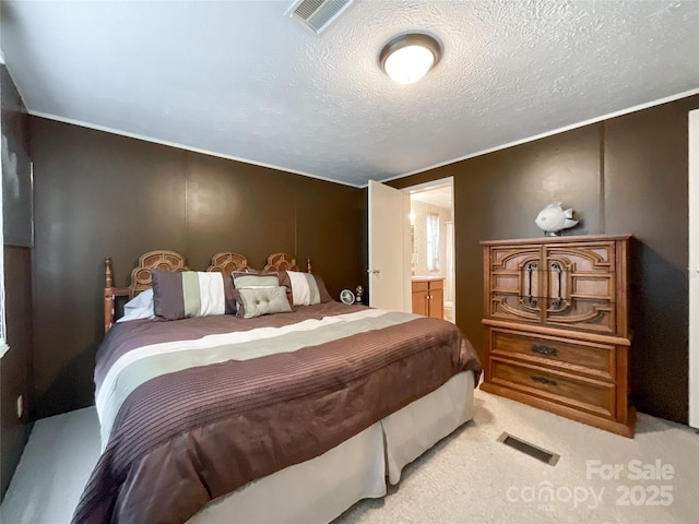 bedroom featuring light carpet and a textured ceiling