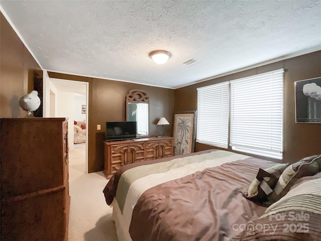 carpeted bedroom featuring a textured ceiling