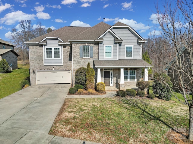 view of front of house featuring a garage, covered porch, and a front yard