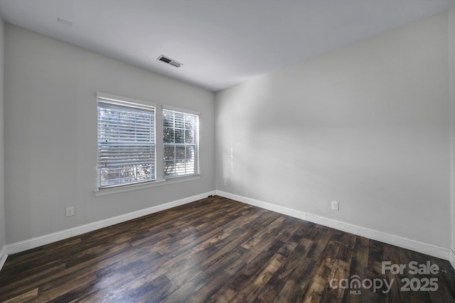 unfurnished room featuring dark wood-type flooring