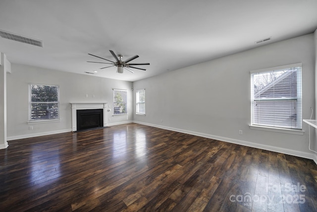 unfurnished living room with dark hardwood / wood-style floors and ceiling fan