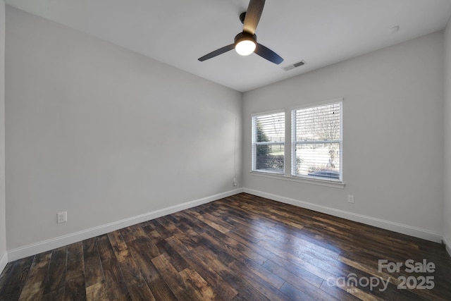 spare room featuring ceiling fan and dark hardwood / wood-style floors