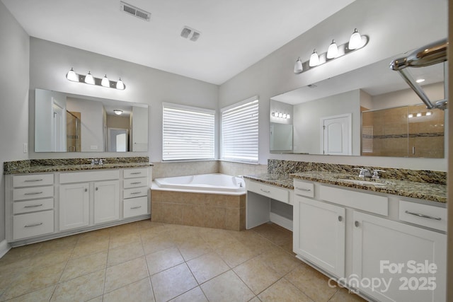 bathroom with tile patterned flooring, vanity, and plus walk in shower