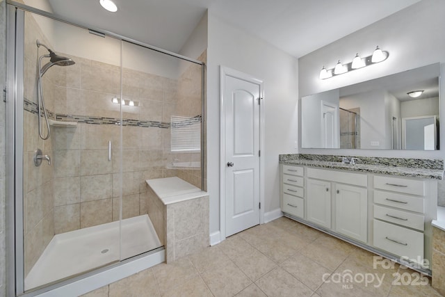 bathroom featuring tile patterned floors, vanity, and a shower with door