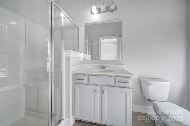 bathroom featuring walk in shower, vanity, and toilet