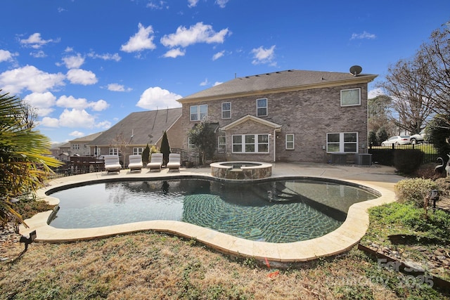 view of pool featuring an in ground hot tub, a patio, and central air condition unit