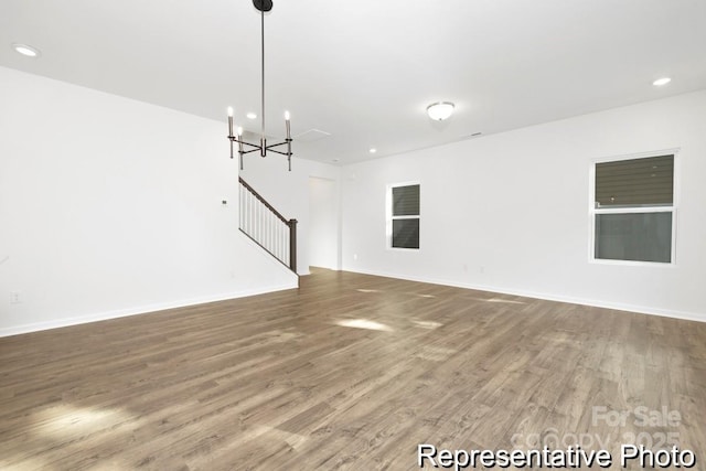 110 Shay Crossing Rd Unit 1P, Salisbury, NC 28144 - unfurnished living room featuring stairway, wood finished floors, a chandelier, and recessed lighting