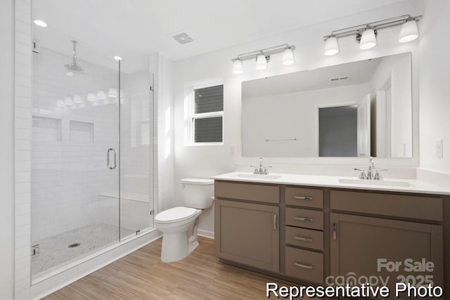 110 Shay Crossing Rd Unit 1P, Salisbury, NC 28144 - bathroom featuring double vanity, a shower stall, and wood finished floors