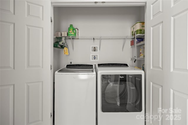 clothes washing area with washer and clothes dryer