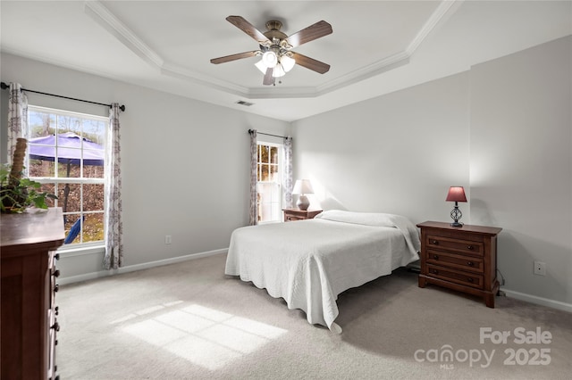 bedroom featuring crown molding, ceiling fan, a raised ceiling, and light carpet