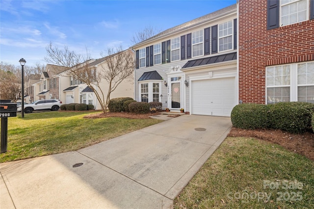 view of front of house with a garage and a front yard