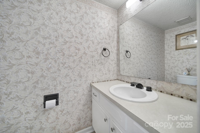 bathroom featuring vanity and a textured ceiling