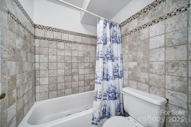 bathroom featuring tile walls, toilet, and shower / bath combination with curtain