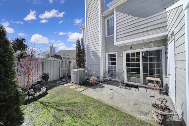 view of yard featuring central AC unit and a patio