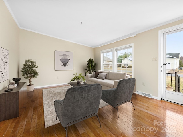 449 Riverwind Dr, Hendersonville, NC 28739 - living area with baseboards, ornamental molding, visible vents, and hardwood / wood-style flooring
