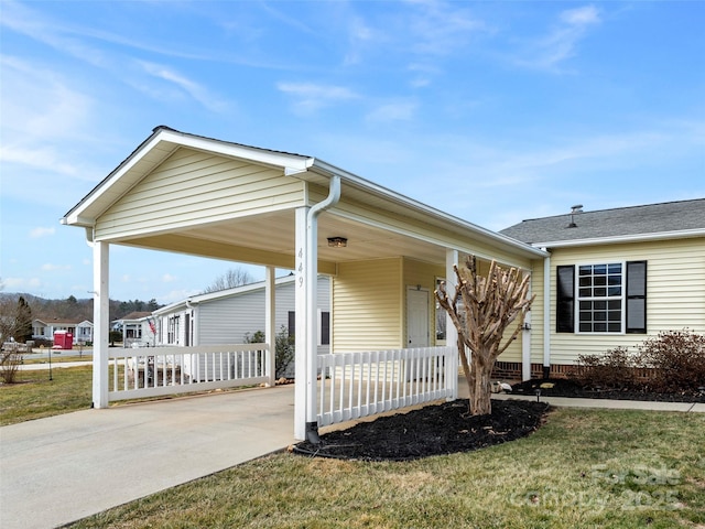 449 Riverwind Dr, Hendersonville, NC 28739 - view of front of home featuring a porch, a front yard, an attached carport, and concrete driveway