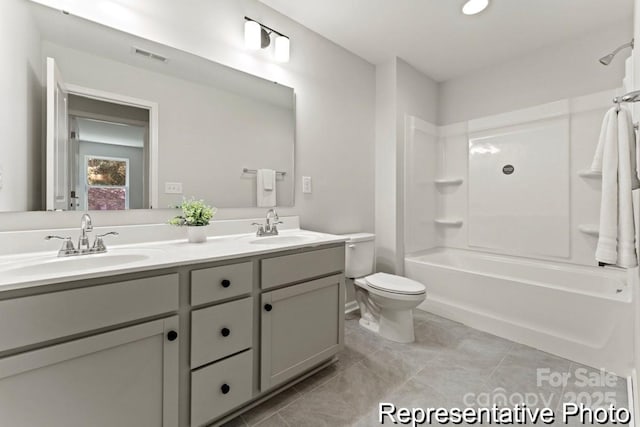 full bathroom featuring vanity, bathtub / shower combination, and toilet