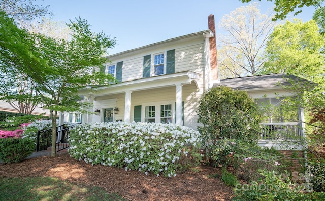 view of front of property featuring a porch and a chimney