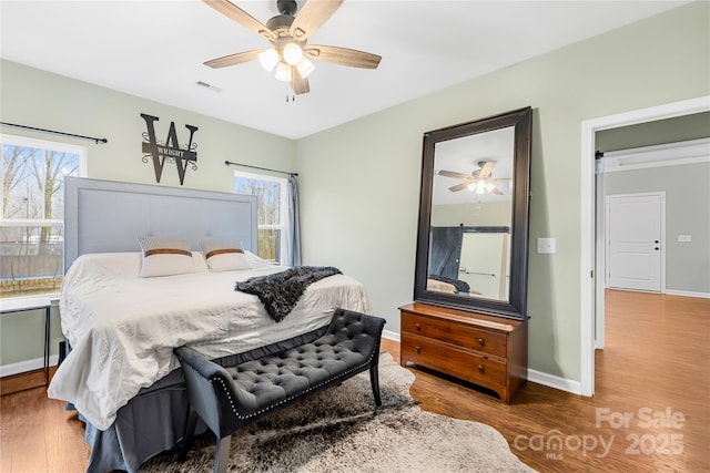 bedroom with ceiling fan and hardwood / wood-style floors