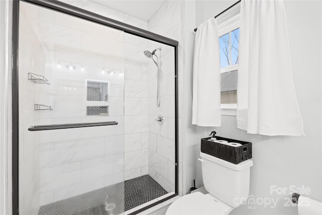 bathroom with an enclosed shower and toilet