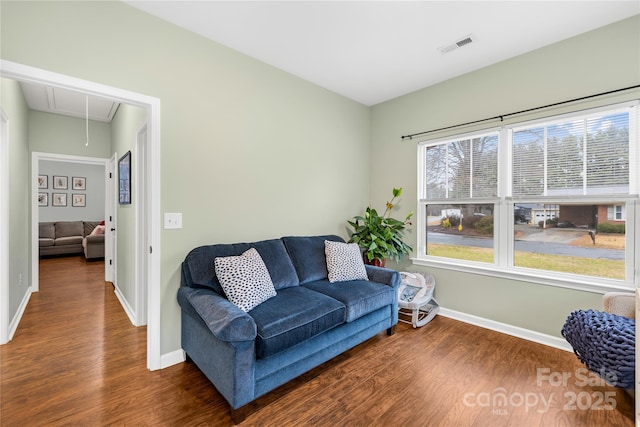 sitting room with dark wood-type flooring