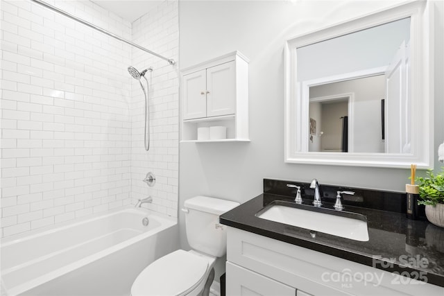 full bathroom with vanity, tiled shower / bath combo, and toilet