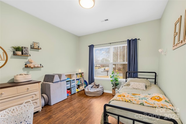 bedroom with dark wood-type flooring