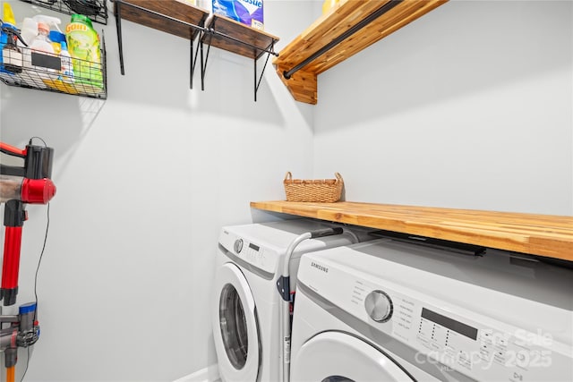 clothes washing area with washing machine and clothes dryer