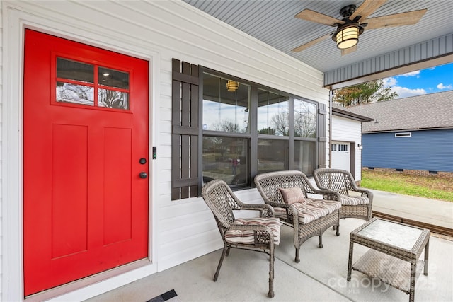 entrance to property with ceiling fan and covered porch