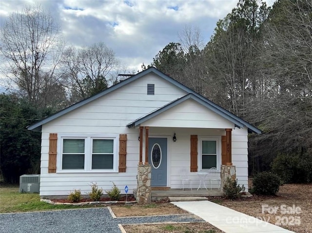 bungalow-style home with central AC and covered porch