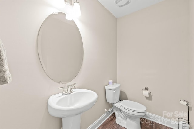 bathroom featuring sink, hardwood / wood-style flooring, and toilet