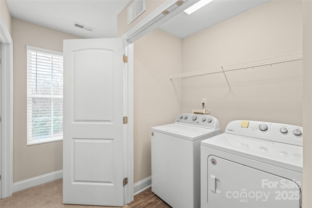 washroom featuring a healthy amount of sunlight and washer and clothes dryer