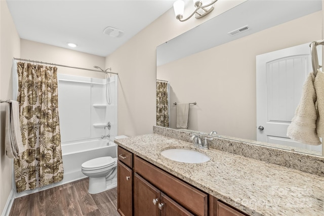 full bathroom featuring shower / bath combo, hardwood / wood-style floors, vanity, and toilet