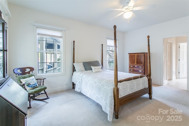 bedroom featuring baseboards, a ceiling fan, and light carpet