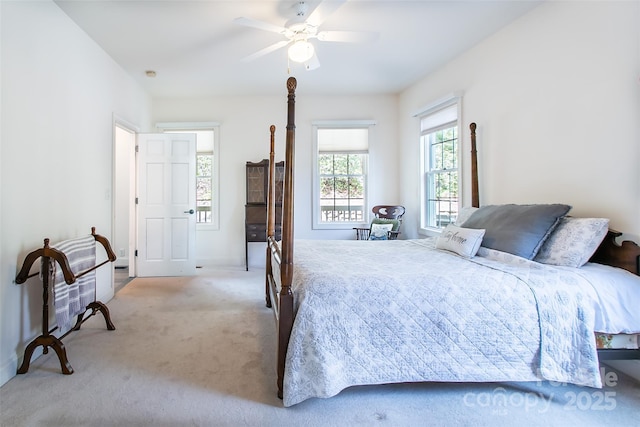 bedroom with light colored carpet and a ceiling fan