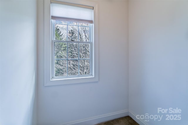 spare room with baseboards