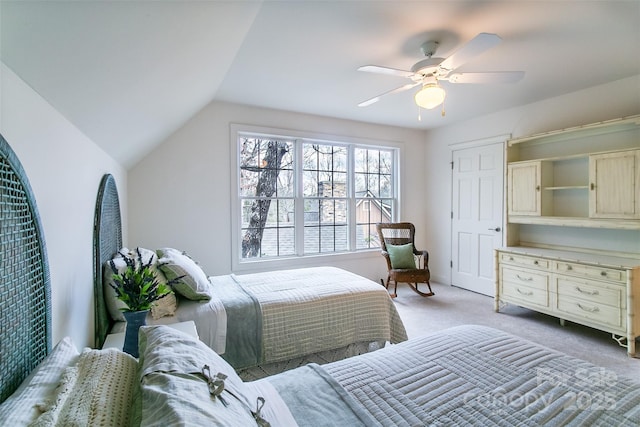 bedroom featuring light colored carpet, lofted ceiling, and a ceiling fan