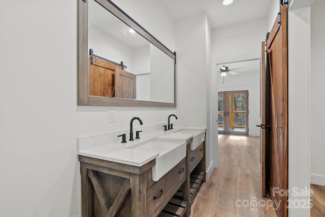 bathroom featuring vanity, hardwood / wood-style flooring, and ceiling fan