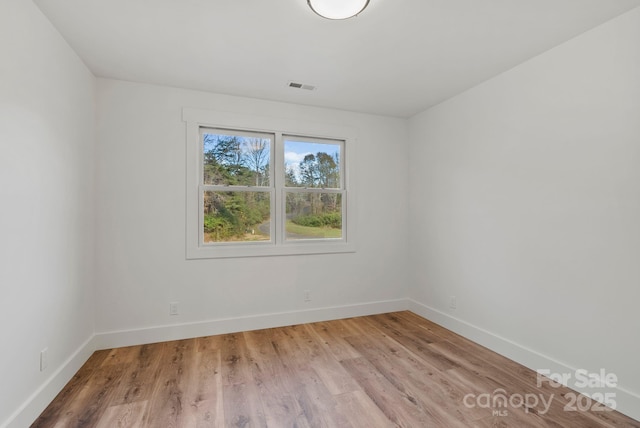 empty room with hardwood / wood-style flooring