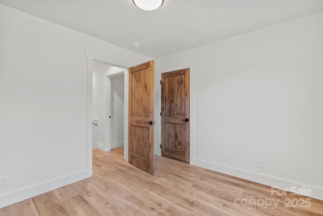 empty room with light hardwood / wood-style floors