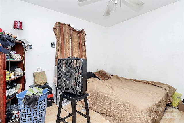 bedroom with ceiling fan and light wood-type flooring