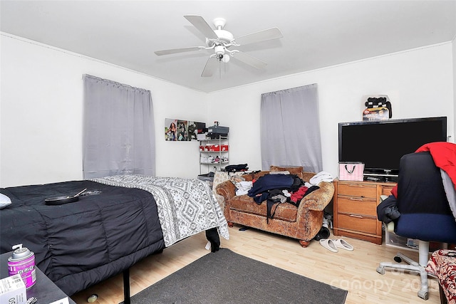 bedroom with ceiling fan and hardwood / wood-style floors