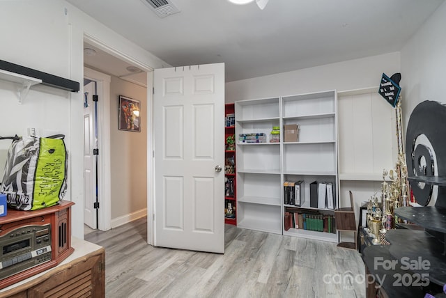 interior space with light wood-style flooring and visible vents