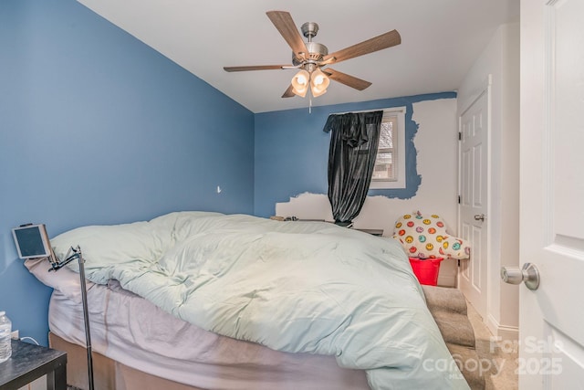 carpeted bedroom featuring ceiling fan and baseboards